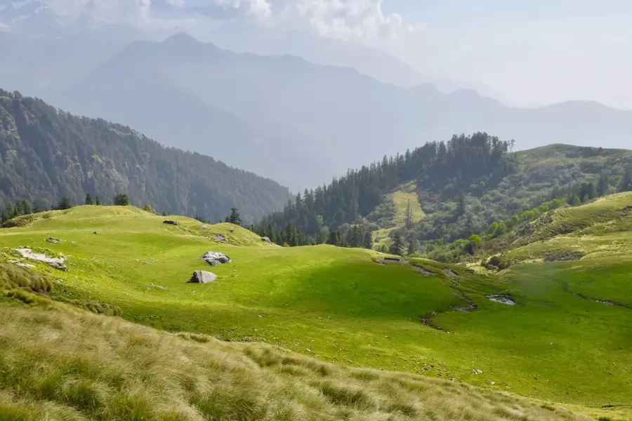 View of green meadows surrounded by hills.