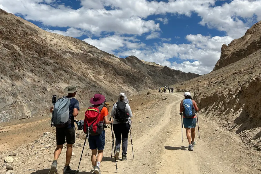 Trekkers walking on a trail in Ladakh mountains