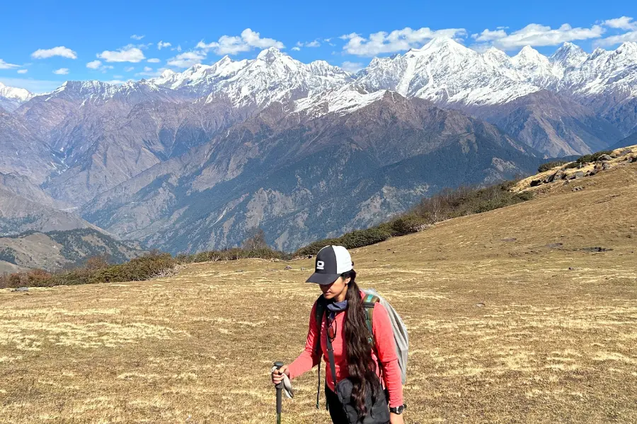 View of trekker walking with Himalayan peaks in background